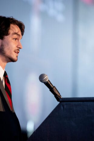 Cole Leathers, president of W&J's Student Government Association, stands at a podium.