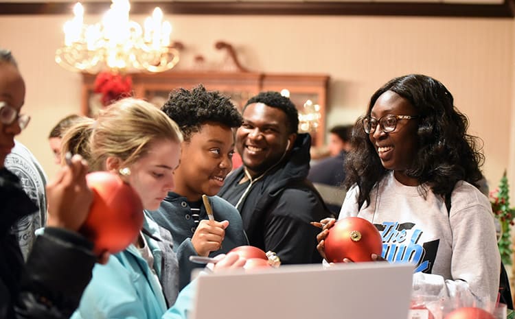 Students gather in the President's Dining Room on W&J's campus to sign ornaments.