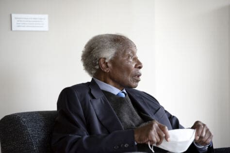 Dr. Walter Cooper talks with W&amp;J student Dejah Hall as he sits under his portrait and a quote of his in the lobby of the building named after him after the dedication of Dr. Walter Cooper í50 Hall October 2, 2020 on the campus of Washington &amp; Jefferson College.